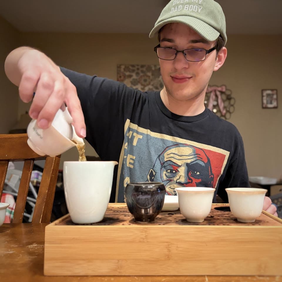 Matthew preparing tea at a tasting table